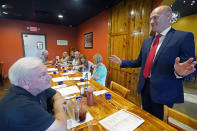 Former Navy pilot Michael Cassidy, right, speaks to a gathering of potential voters in Magee, Miss., June 15, 2022, as he seeks support for his runoff race against U.S. Rep. Michael Guest in the Republican primary of Mississippi's 3rd Congressional District. (AP Photo/Rogelio V. Solis)