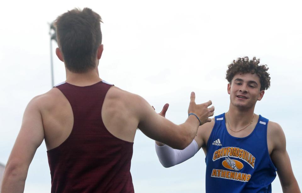 McCutcheon Matthew Hughes celebrates with Crawfordsville Alec Saidian after the 110m hurdles during the IHSAA boy’s track and field sectional meet, Thursday, May 16, 2024, at West Lafayette High School in West Lafayette, Ind.