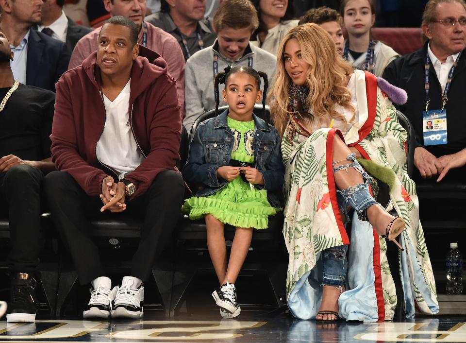 (L-R) Jay-Z, Blue Ivy Carter, and Beyoncé Knowles-Carter attend the 66th NBA All-Star Game at Smoothie King Center on Feb. 19, 2017, in New Orleans, Louisiana.