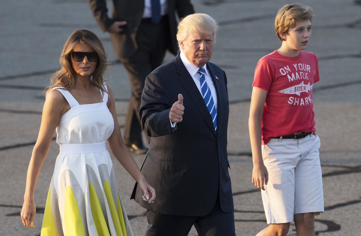 Melania Trump, then-President Donald Trump and their son Barron walk to board Air Force One (Saul Loeb / AFP via Getty Images)