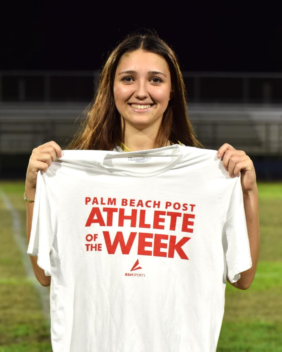 Olympic Heights' Avi Solorzano poses with her Athlete of the Week shirt after being recognized as a county winner on Nov. 27, 2023.