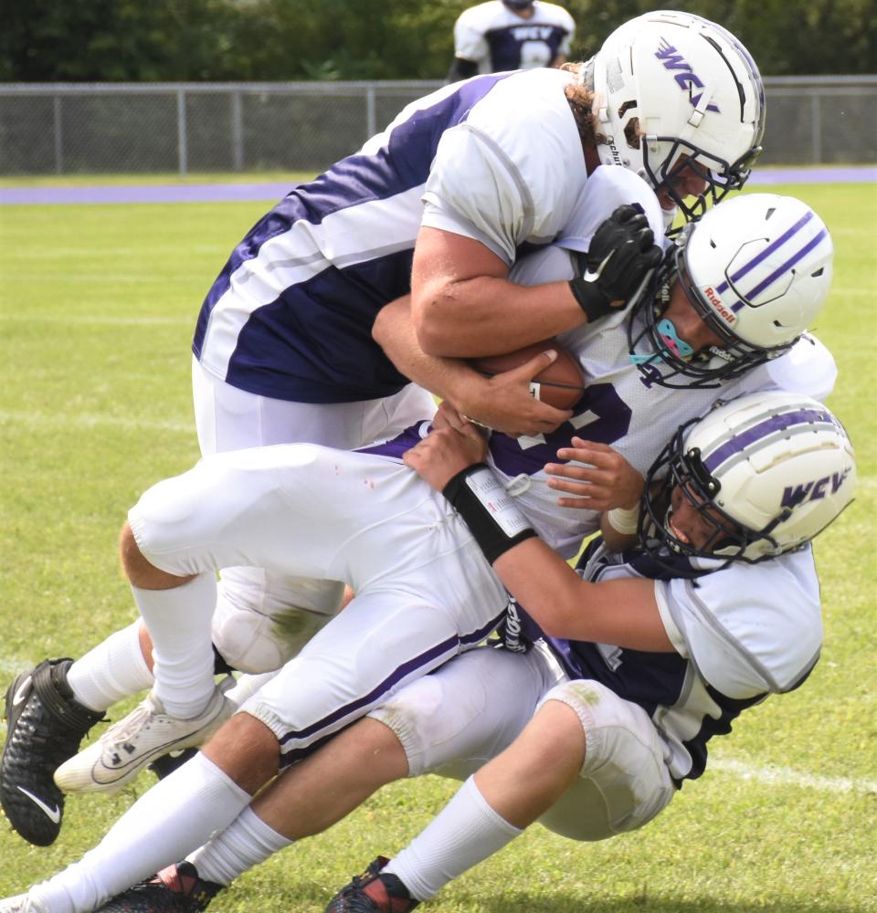 Ticonderoga quarterback Tommy Montalbano (8) gets squeezed between West Canada Valley tacklers Blake Reese (left) and Dominic DiFillippo during Saturday's game.