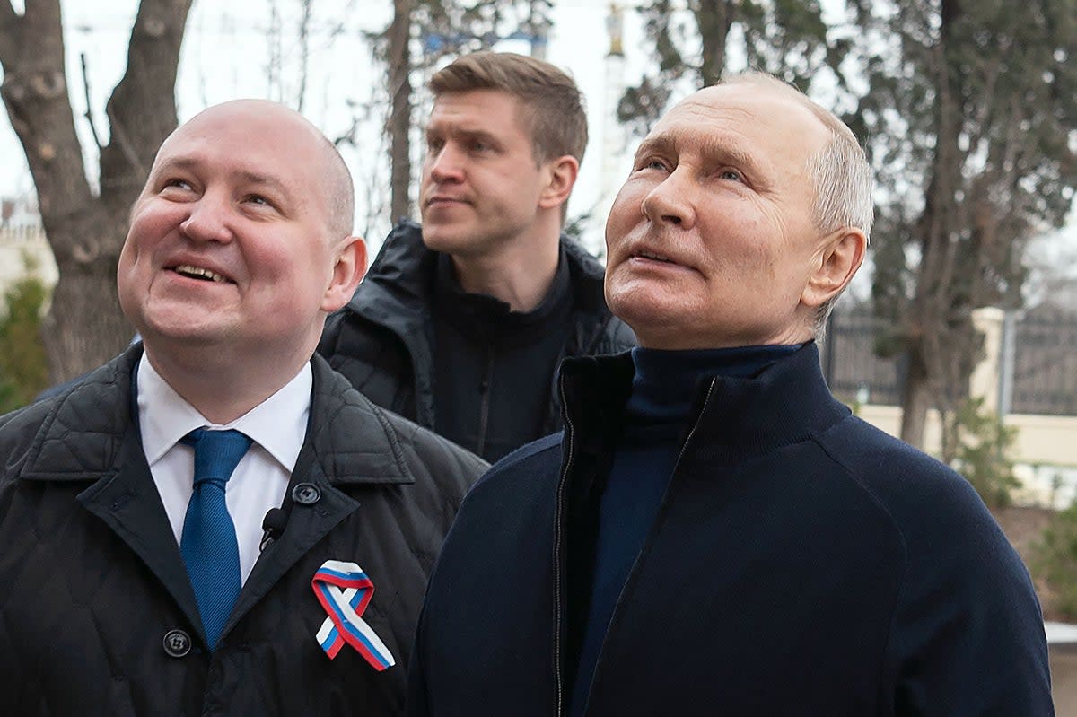 Handout photograph taken and released by the Russian government shows Putin (right), with Governor Mikhail Razvozhayev at the Chersonesos Taurica historical and archeological park in Sevastopol (Russian Presidential Press Office/AFP/Getty)