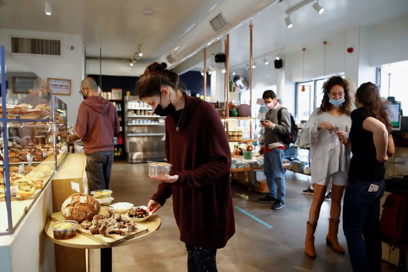 An employee displays food at a cafe as Israel further eases the coronavirus disease (COVID-19) restrictions in Tel Aviv