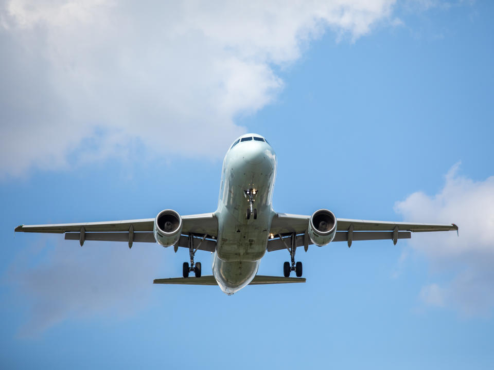 Toronto (Mississauga) Canada; an unidentified light colored twin engine jet airplane approaching with wheels down for landing