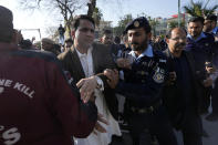 Police officers stop stock market traders trying to march towards the Swedish Embassy, in Islamabad, Pakistan, Friday, Jan. 27, 2023, during a protest against the burning of Quran, a Muslim holy book, by a Danish anti-Islam activist. (AP Photo/Anjum Naveed)