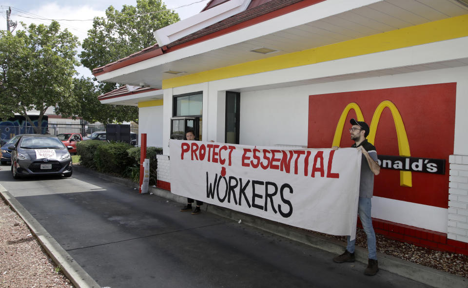 FILE - In this April 21, 2020, file photo, people protest what they say is a lack of personal protective equipment for employees as they close down the drive-thru at a McDonald's restaurant in Oakland, Calif. Across the country, the new, unexpected front-line workers of the pandemic — from grocery store and fast food workers to Instacart shoppers and Uber drivers — are taking action to protect themselves. (AP Photo/Ben Margot, File)