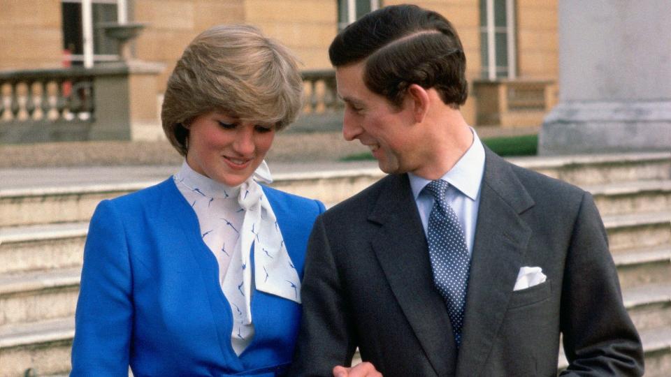 Princess Diana and Prince charles laughing with each other during their engagement announcement photoshoot