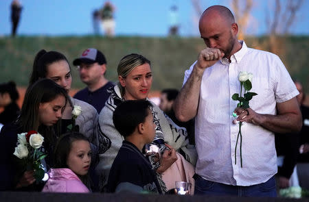 Will Beck, a survivor of the attack at Columbine high school (R), cries with his family at the Columbine memorial a day before the school shooting's 20th anniversary, in Littleton, Colorado, U.S., April 19, 2019. REUTERS/Rick Wilking