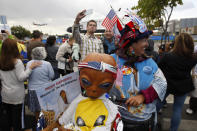 Vivian Robinson dresses up and carries a model from the movie E.T. on her bicycle to see the space shuttle Endeavour as it is transported from Los Angeles International Airport (LAX) to the California Science Center in Exposition Park where it will be on permanent public display on October 12, 2012 in Los Angeles, California. Endeavour was flown cross-country atop NASA's Shuttle Carrier Aircraft from Kennedy Space Center in Florida to LAX on its last flight ever on September 21. Completed in 1991, Endeavour was built to replace the space shuttle Challenger which disintegrated during a catastrophic re-entry accident. This fifth and final space shuttle orbiter circled the earth 4,671 times and traveled nearly 123 million miles during its 25 missions from 1992 to 2011. (Photo by David McNew/Getty Images)