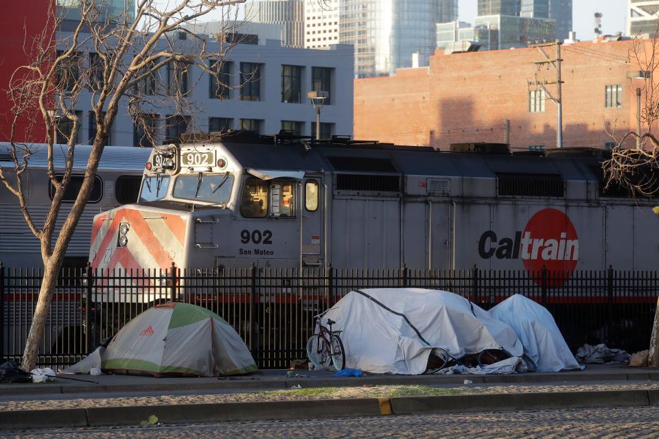 Tents are shown in front of a Caltrain commuter rail in San Francisco. The city has a surging homelessness problem across California has drawn the ire of President Donald Trump. On Wednesday, California Gov. Gavin Newsom used his second State of the State speech to lay out measures that will be used to provide help to the homeless.