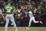San Diego Padres' Fernando Tatis Jr., right, runs the bases after hitting a home run off Oakland Athletics starting pitcher James Kaprielian, left, during the third inning of a baseball game Tuesday, July 27, 2021, in San Diego. (AP Photo/Derrick Tuskan)