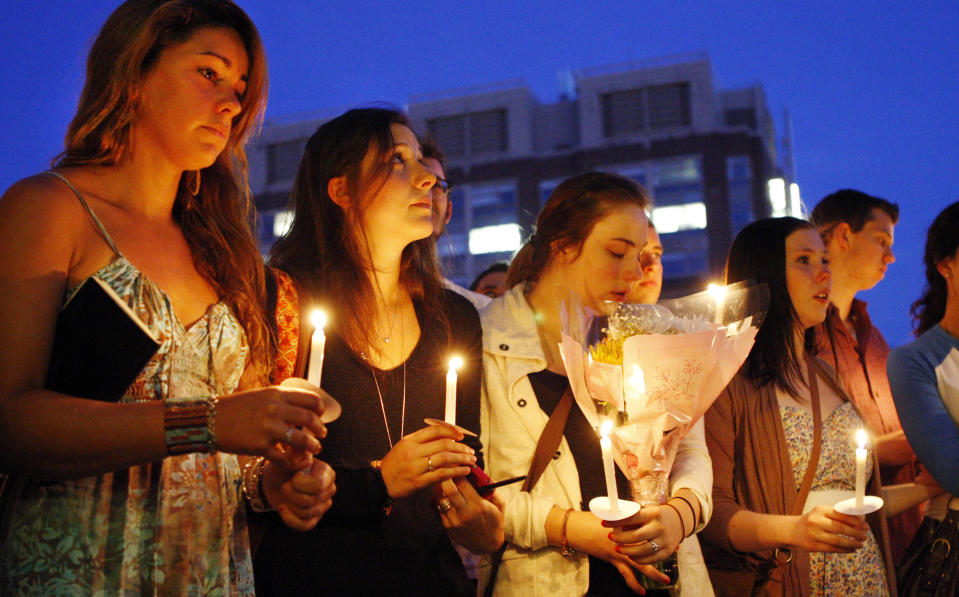 Boston University students including Tori Pinheiro, left, of New Bedford, Mass., and Austin Brashears' girlfriend, holds a candlelight vigil on Marsh Plaza at Boston University, Saturday, May 12, 2012, for three students studying in New Zealand who were killed when their minivan crashed during a weekend trip. At least five other students were injured in the accident, including one who was in critical condition. Boston University spokesman Colin Riley said those killed in the accident were Daniela Lekhno, 20, of Manalapan, N.J.; Brashears, 21, of Huntington Beach, Calif.; and Roch Jauberty, 21, whose parents live in Paris. (AP Photo/Bizuayehu Tesfaye)