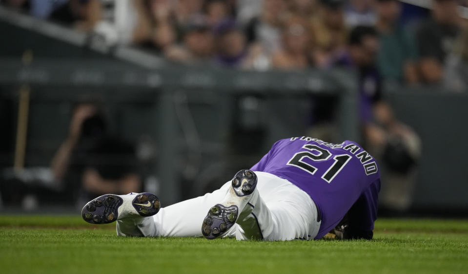 Colorado Rockies starting pitcher Kyle Freeland falls to the ground after being hit by a single off the bat of Chicago Cubs' Andrew Romine in the fifth inning of a baseball game Tuesday, Aug. 3, 2021, in Denver. Freeland remained on the mound through the inning but was pulled in the top of the sixth. (AP Photo/David Zalubowski)