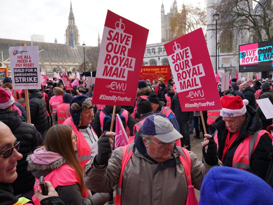 Striking postal workers brandish placards reading ‘Save Our Royal Mail’ at Parliament Square rally (PA)