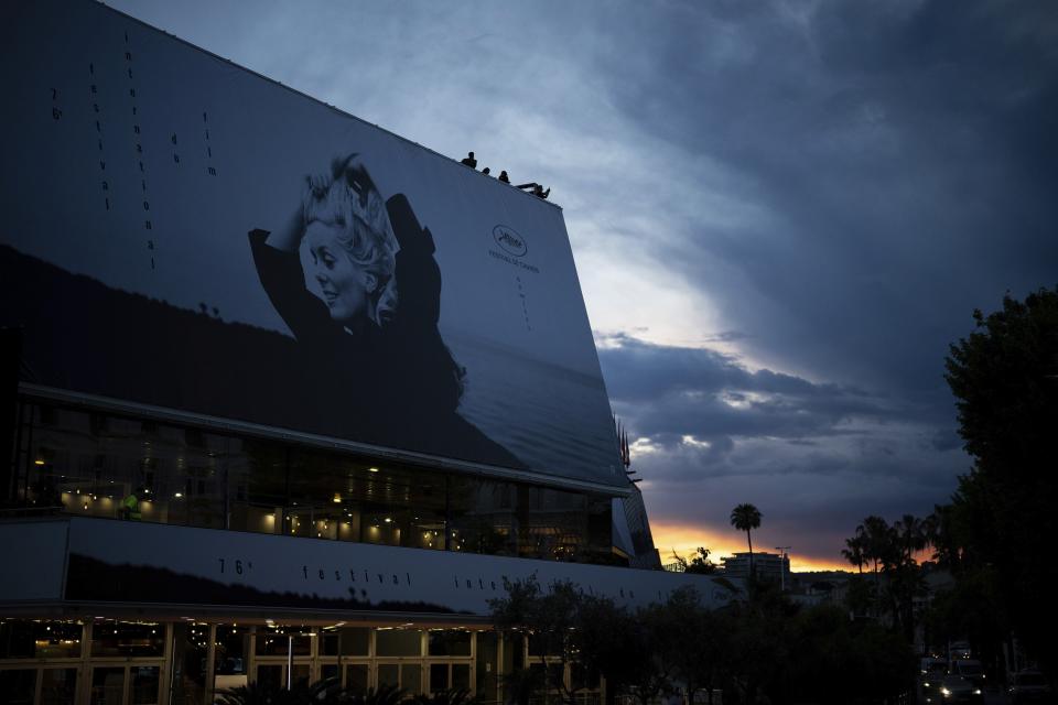 The official poster featuring actress Catherine Deneuve from the film 'La Chamade' is pictured on the facade of the Palais des Festivals ahead of the Cannes film festival, in Cannes, southern France, Sunday, May 14, 2023. The 76th edition of the film festival runs from May 16 until May 27. (AP Photo/Daniel Cole)