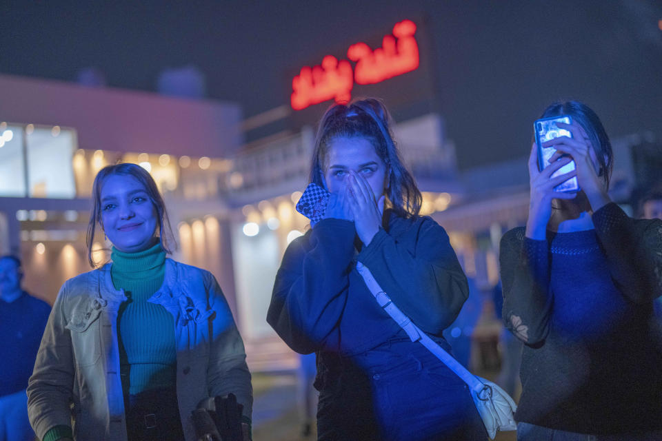 Youths gather along the Tigris River for a concert by rap artist OG Khalifa in Baghdad, Iraq, Saturday Feb. 25, 2023. One of the songs he performs mocks “sheikhs,” those who wield power in the new Iraq through wealth or political connections. (AP Photo/Jerome Delay)