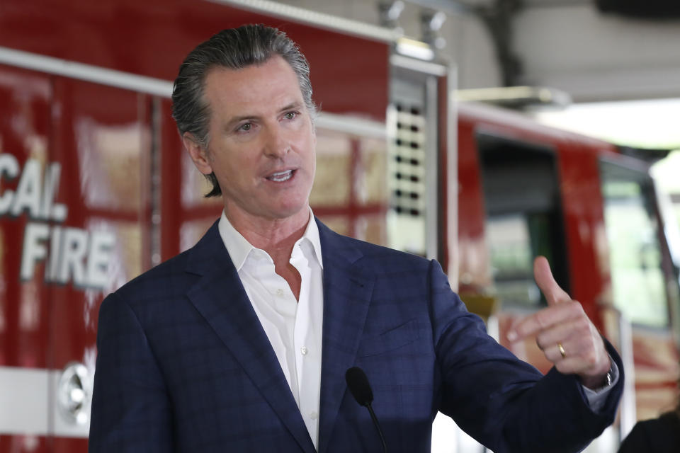 FILE - In this May 13, 2020 file photo, Gov. Gavin Newsom discusses his revised state budget proposal during a news conference at the CalFire/Cameron Park Fire Station in Cameron Park, Calif. Many state and local governments across the country have suspended public records requirements amid the coronavirus pandemic. Newsom declined for a while to release details of a nearly $1 billion contract to buy protective masks from a Chinese company. And numerous California municipalities have stopped or slowed their fulfillment of open-records requests.(AP Photo/Rich Pedroncelli, Pool)