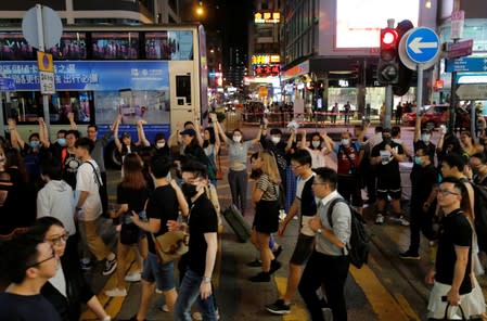 Protesters hold hands to form a human chain during a rally to call for political reforms at Mongkok district in Hong Kong