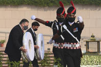 U.S. Secretary of State Mike Pompeo, left, and Secretary of Defence Mark Esper pay their tributes at the National War Memorial in New Delhi, India, Tuesday, Oct. 27, 2020. In talks on Tuesday with their Indian counterparts, Pompeo and Esper are to sign an agreement expanding military satellite information sharing and highlight strategic cooperation between Washington and New Delhi with an eye toward countering China. (Jewel Samad/Pool via AP)