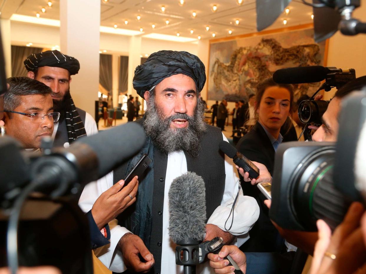 Taliban leader Mullah Abdul Salam Zaeef (centre), who served as ambassador to Pakistan during the Taliban's rule, speaks to the media as he arrives to the signing of the US-Taliban agreement in Doha, Qatar, 29 February 2020: AP