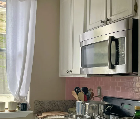 pink peel and stick backsplash on wall