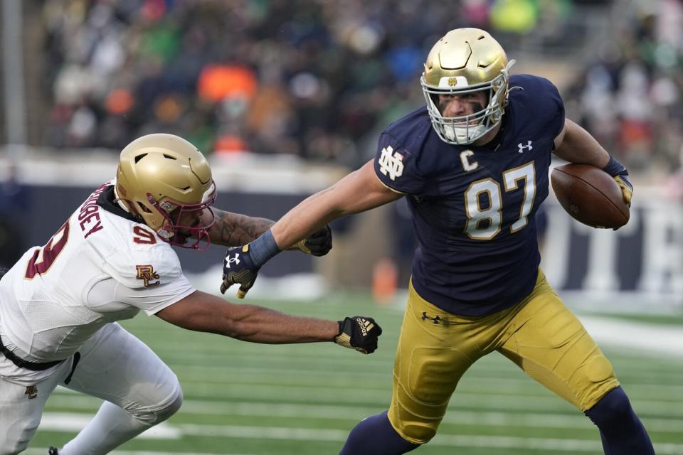 Notre Dame tight end Michael Mayer runs past Boston College defensive back Jaiden Woodbey.