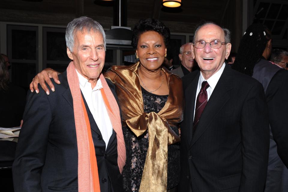 FILE - This Oct. 17, 2011 file photo shows legendary songwriters Bert Bacharach, left, and Hal David pose with singer Dionne Warwick at the