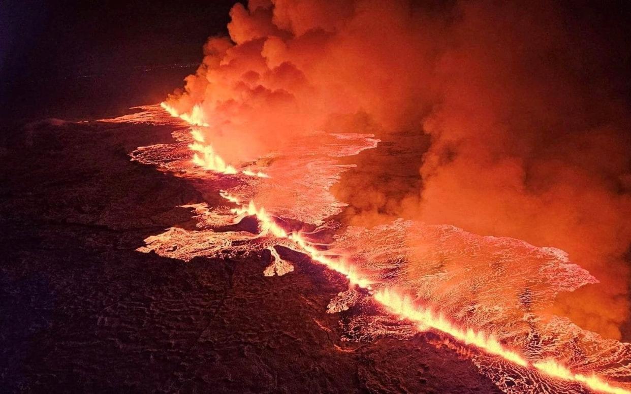 A volcano spews lava and smoke as it erupts in Grindavik, Iceland on December 18, 2023