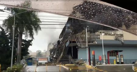 Smoke billows from a mall, a day after a fire broke out in Davao City, the Philippines, in this still image taken a December 24, 2017 social media video. Ana Rose Novicio/via REUTERS