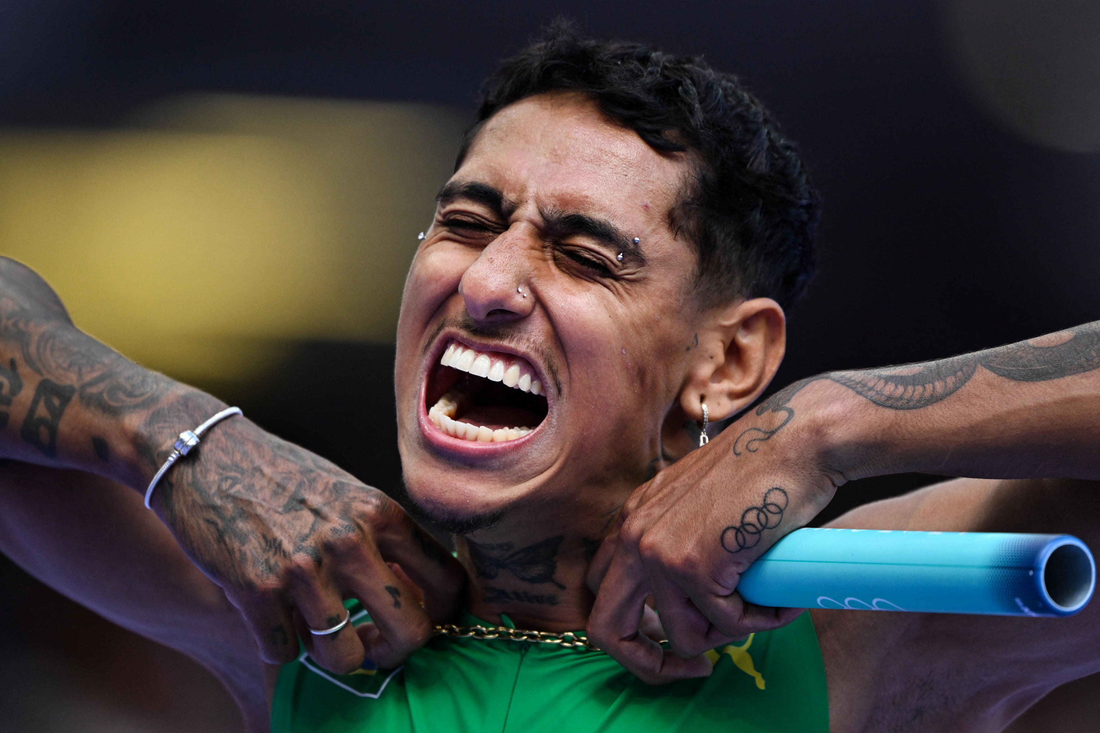 Brazil's Gabriel Dos Santos reacts in the men's 4x100m relay heat of the athletics event at the Paris 2024 Olympic Games at Stade de France in Saint-Denis, north of Paris, on August 8, 2024. (Kirill Kudryavtsev/AFP/Getty Images) 