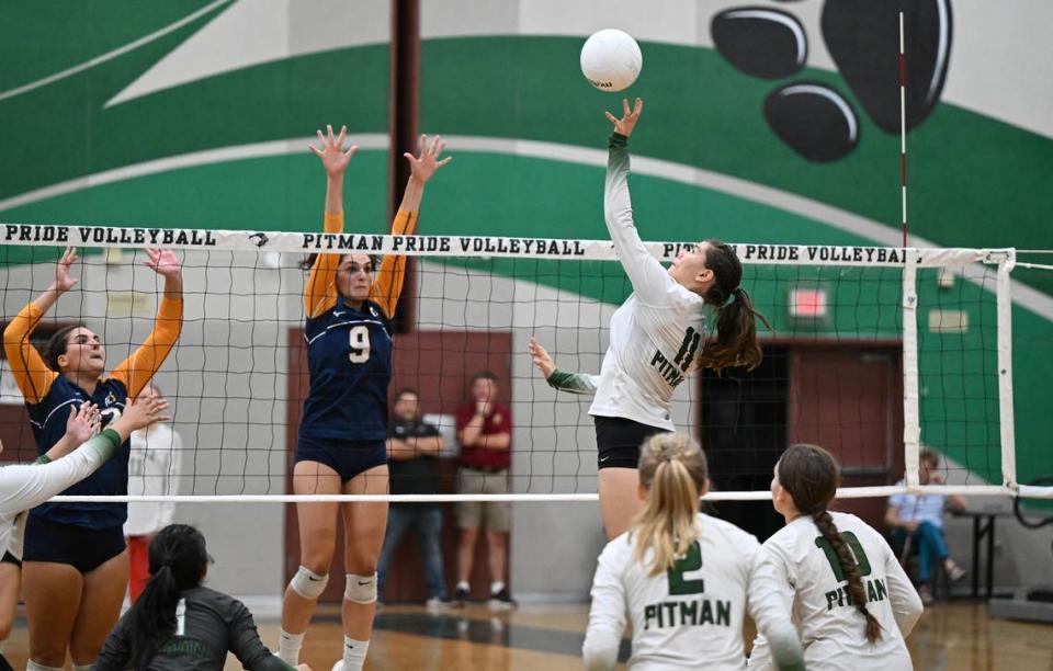 Pitman’s Ella Sniezek (11) floats the ball over the net during the non-league match with Oak Ridge at Pitman High School in Turlock, Calif., Thursday, September 7, 2023.