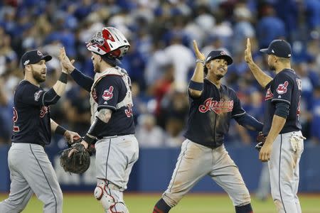 Oct 17, 2016; Toronto, Ontario, CAN; Cleveland Indians second baseman Jason Kipnis (far left), catcher Roberto Perez (second from left), shortstop Francisco Lindor (second from right), and left fielder Coco Crisp (far right) celebrate after game three of the 2016 ALCS playoff baseball series against the Toronto Blue Jays at Rogers Centre. Mandatory Credit: John E. Sokolowski-USA TODAY Sports