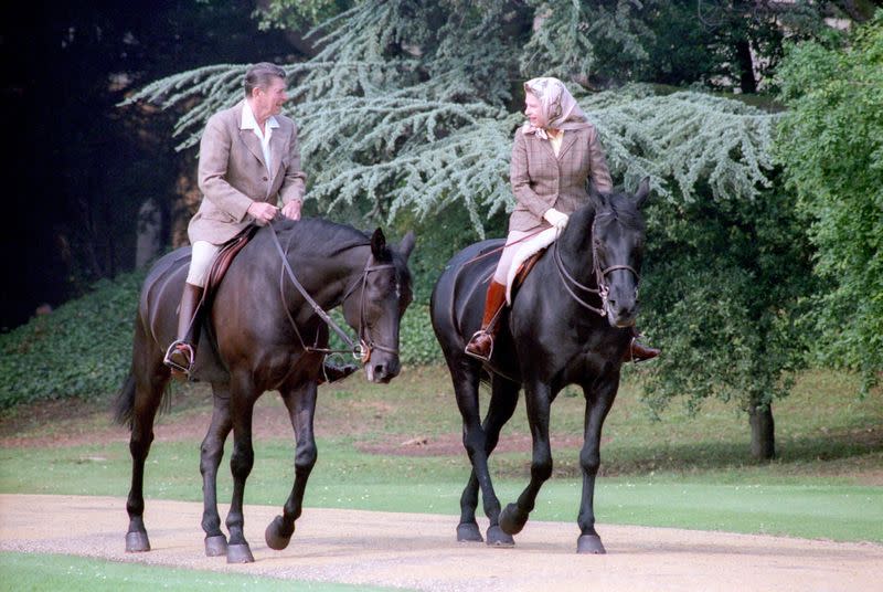 FILE PHOTO: Ronald Reagan rides horses with Queen Elizabeth at Windsor Castle