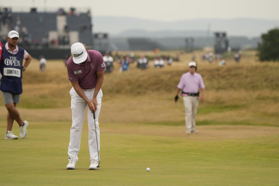 FILE - Cameron Smith, of Australia, putts on the 17th green during the final round of the British Open golf championship on the Old Course at St. Andrews, Scotland, Sunday July 17, 2022. His putt from 40 yards off the green with the Road Hole bunker in his way set up the crucial par putt for him to win the Open. (AP Photo/Gerald Herbert, File)