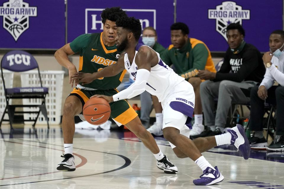 North Dakota State guard Dezmond McKinney (0) defends as TCU guard Mike Miles (1) works on the perimeter in the first half of an NCAA college basketball game in Fort Worth, Texas, Tuesday, Dec. 22, 2020. (AP Photo/Tony Gutierrez)