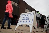 Voters wait in line to cast ballots on the first day of early voting in New York