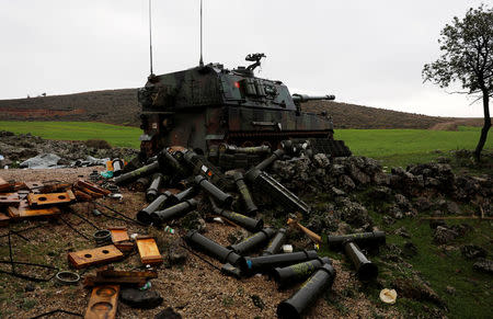 Empty shells are seen next to a Turkish army personnel carrier (APC) on the Turkish-Syrian border in Hatay province, Turkey January 23, 2018. REUTERS/Umit Bektas