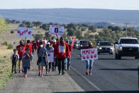 In this image provided by the Navajo Nation Office of the Speaker, family members and advocates participating in a walk on the Navajo Nation, Wednesday, May 5, 2021, near Window Rock, Ariz., to commemorate a day of awareness for the crisis of violence against Indigenous women and children. (Byron C. Shorty, Navajo Nation Office of the Speaker via AP)