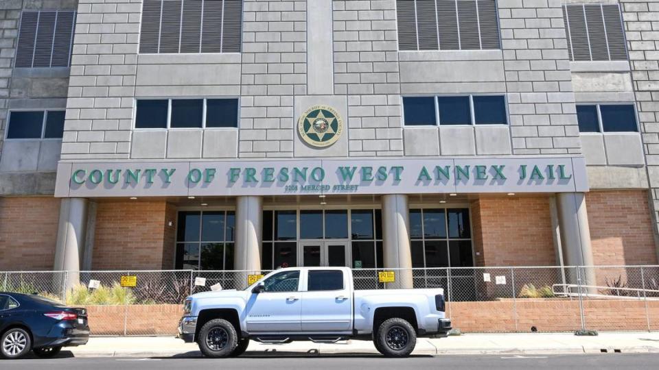 The entrance to the new Fresno County West Annex Jail building in downtown Fresno is still closed off with a chain link fence on Wednesday, May 8, 2024 but officials say the building could finally open by the end of the month. CRAIG KOHLRUSS/ckohlruss@fresnobee.com