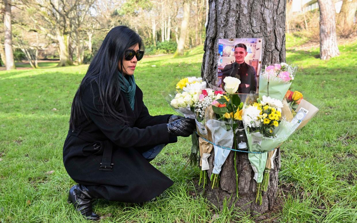 Dolores Wallace-Roberts lays flowers at the site of her son's murder in Bournemouth