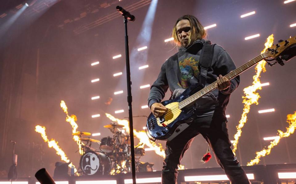 Fall Out Boy’s Pete Wentz plays the bass pyrotechnics exploded behind him and drummer Andy Hurley during the group’s concert Sunday at Golden 1 Center.