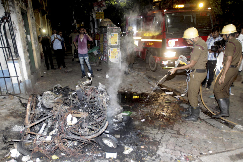 Firemen douse the fire after two wheelers were set on fire during clashes between Bharatiya Janata Party (BJP) workers and students outside the Calcutta University in Kolkata, India, Tuesday, May 14, 2019. Rival political supporters clashed with rocks and sticks during an election rally by the Hindu nationalist party BJP leaving several people injured and a university college vandalized. (AP Photo)