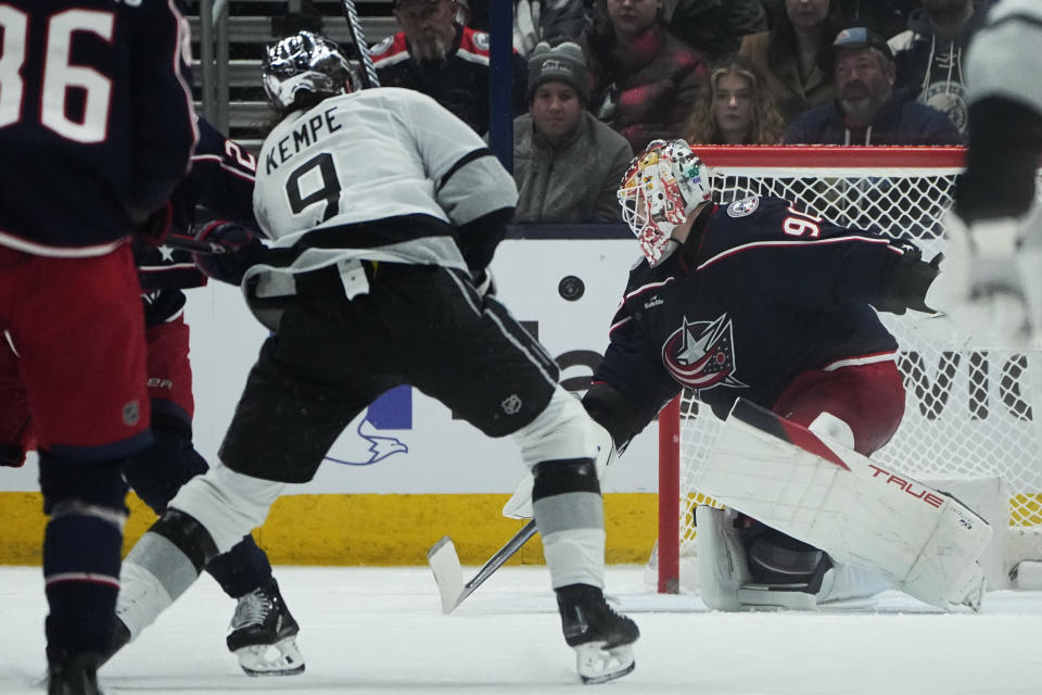 Columbus Blue Jackets goaltender Elvis Merzlikins (90) blocks a shot in front of Los Angeles Kings' Adrian Kempe (9) in the second period of an NHL hockey game, Tuesday, Dec. 5, 2023, in Columbus, Ohio. (AP Photo/Sue Ogrocki)