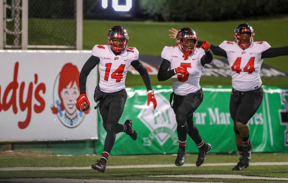 Nov 27, 2021; Huntington, West Virginia, USA; Western Kentucky Hilltoppers defensive back Davion Williams (14) returns an interception for a touchdown during the fourth quarter against the Marshall Thundering Herd at Joan C. Edwards Stadium.