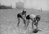 <p>Joan Crawford and Dorothy Sebastian play a friendly game of football while spending the day at the beach in 1927. </p>