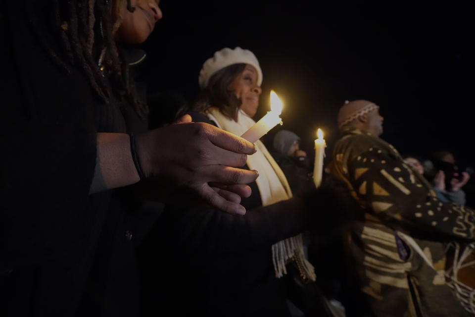People hold candles at a candlelight vigil for Tyre Nichols, who died after being beaten by Memphis police officers, in Memphis, Tenn., Thursday, Jan. 26, 2023. (AP Photo/Gerald Herbert)