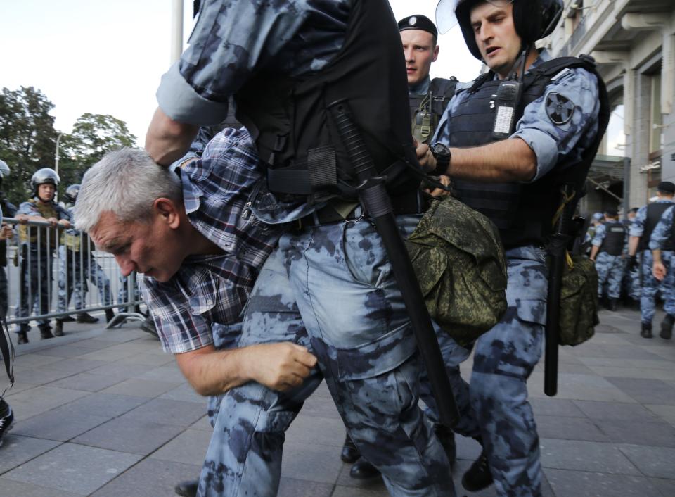Police officers detain a man during an unsanctioned rally in the center of Moscow, Russia, Saturday, July 27, 2019. Russian police are wrestling with demonstrators and have arrested hundreds in central Moscow during a protest demanding that opposition candidates be allowed to run for the Moscow city council. (AP Photo/Alexander Zemlianichenko)