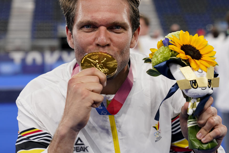 Belgium goalkeeper Vincent Vanasch kisses his gold medal after making the final save in a shootout to win their men's field hockey gold medal match against Australia at the 2020 Summer Olympics, Thursday, Aug. 5, 2021, in Tokyo, Japan. (AP Photo/John Minchillo)