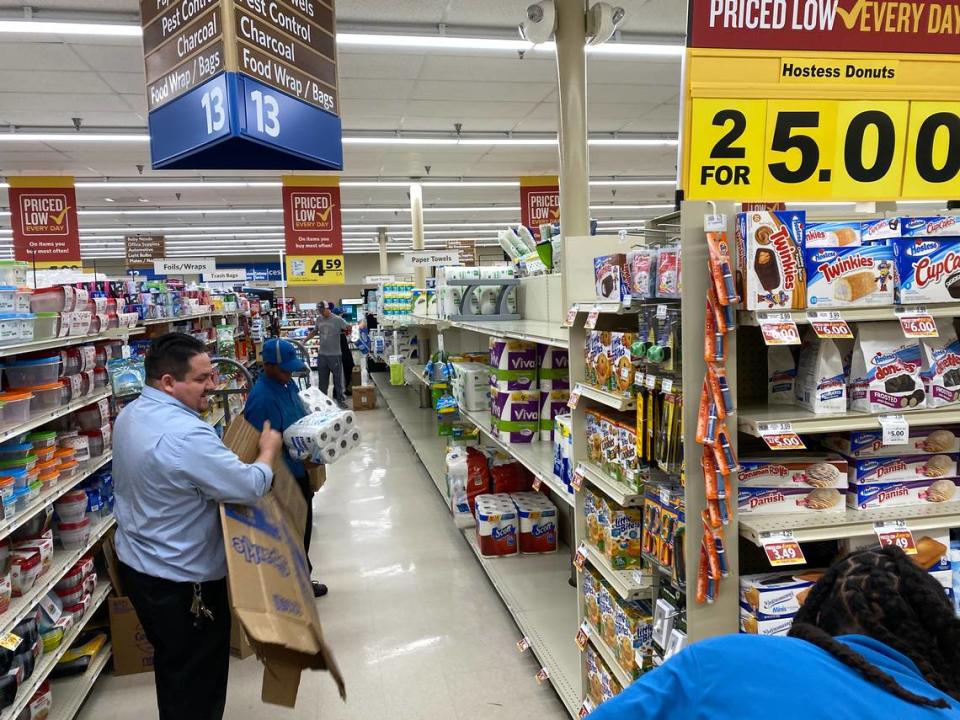 Food Lion employees restock shelves at The Plaza location on March 14, 2020.